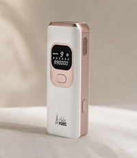 Thumbnail for White and rose gold electronic device with digital display on a beige background